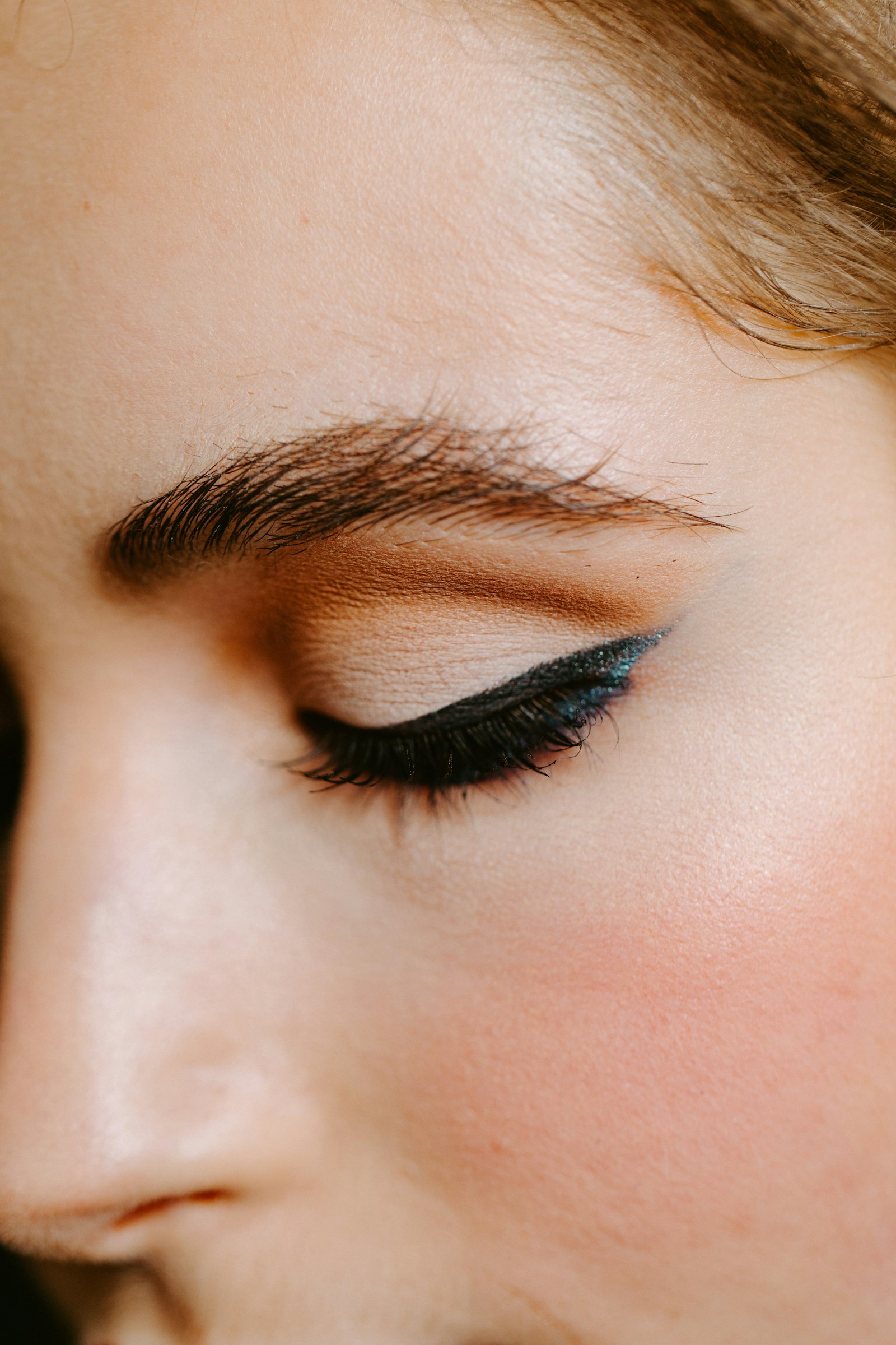 A close view of a professionally shaped eyebrow and eye makeup