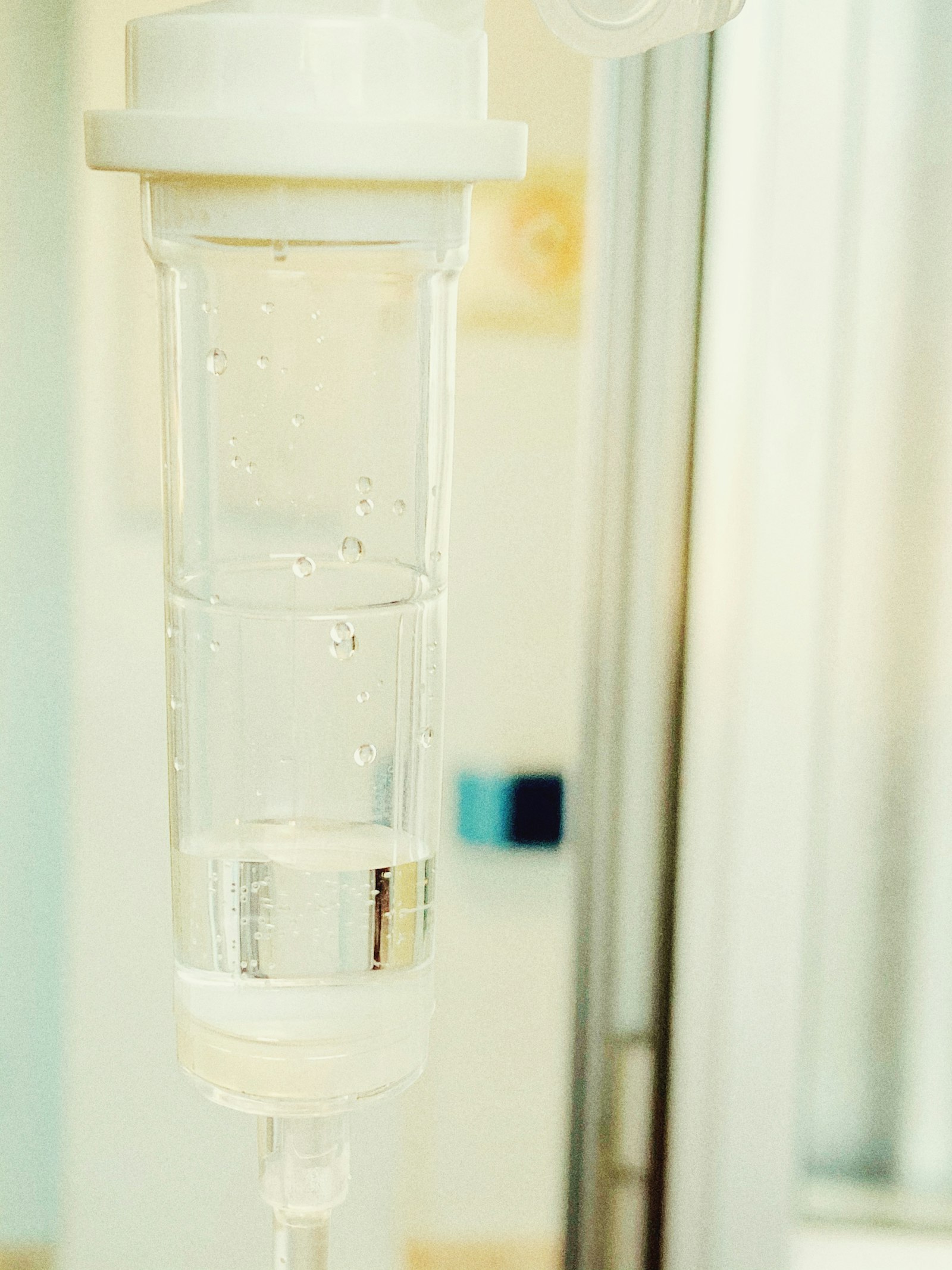 A clear IV drip chamber in a treatment setting