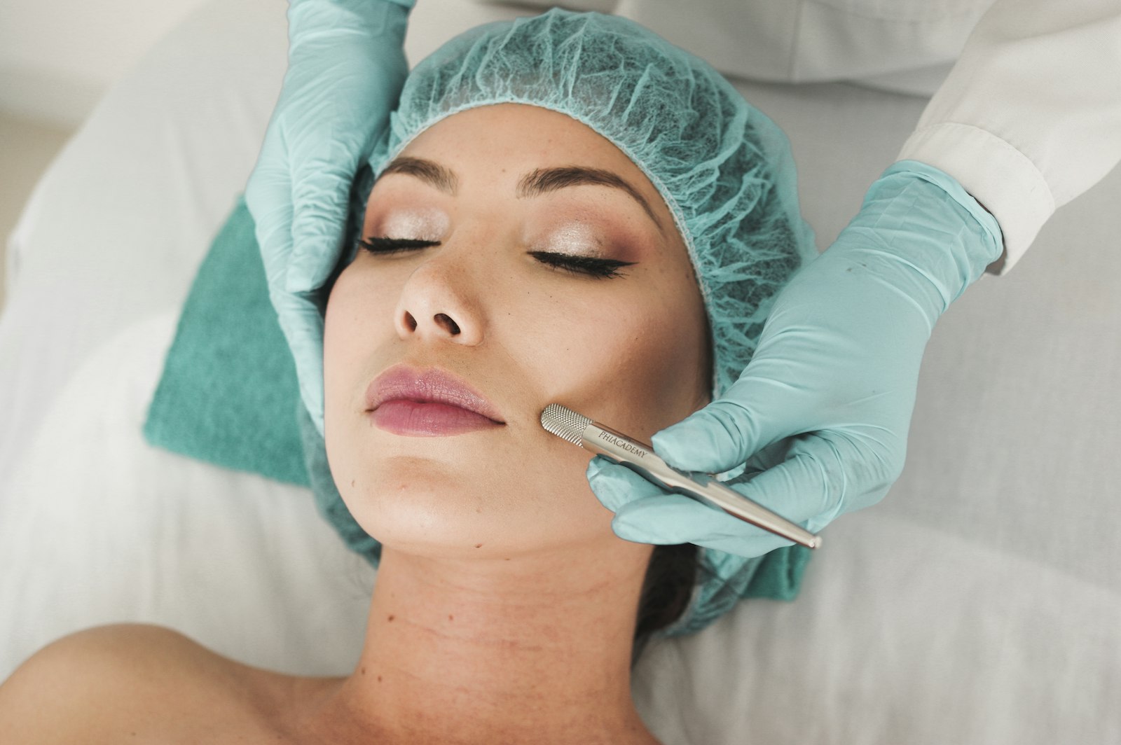 A skincare professional using a treatment tool during a facial